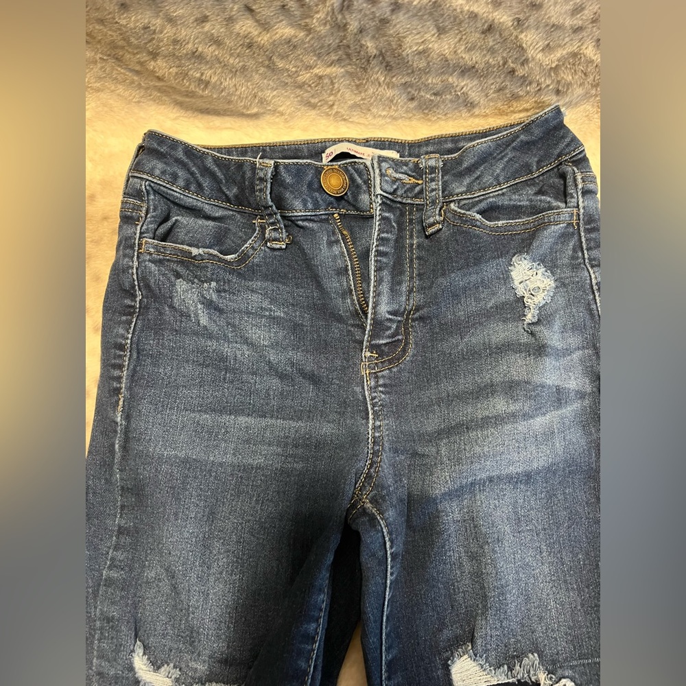Blue ripped jeans with inner patches